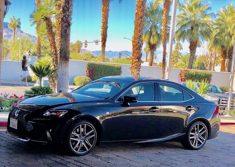 Lexus IS 200t compact luxury sedan set against Palm Desert palm trees