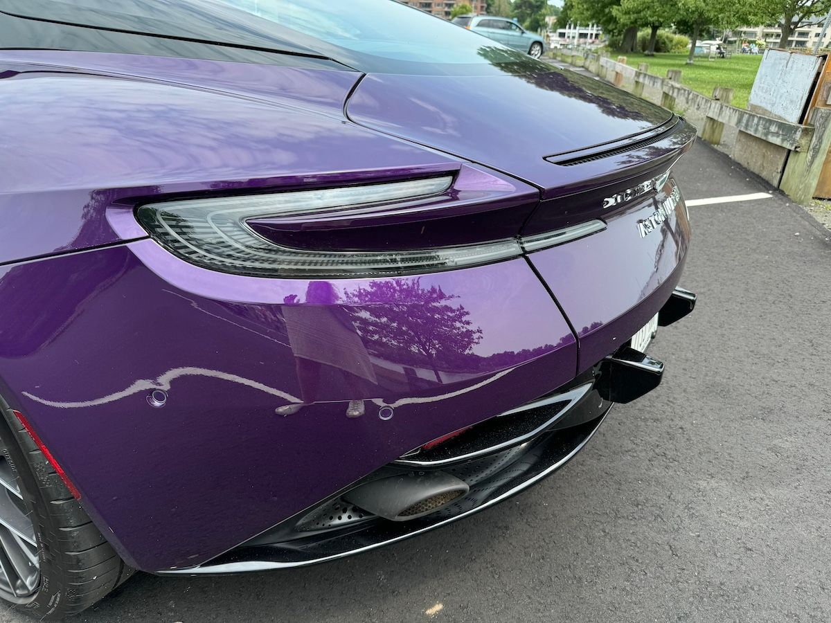 The Rear Of The 2024 Aston Martin Db12 Shows The Iconic Tail Lights And Spoiler