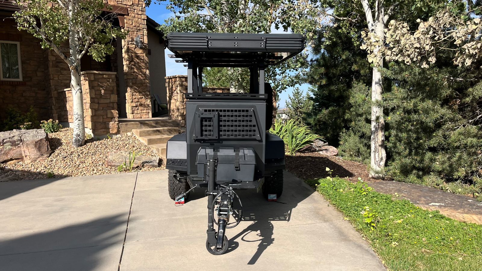A Bear In Your Campground?!? If It's The Taxa Woolly Bear Camper Trailer, You're in Luck 9 The Taxa Woolly Bear Parked In A Driveway, Showcasing The Small Footprint