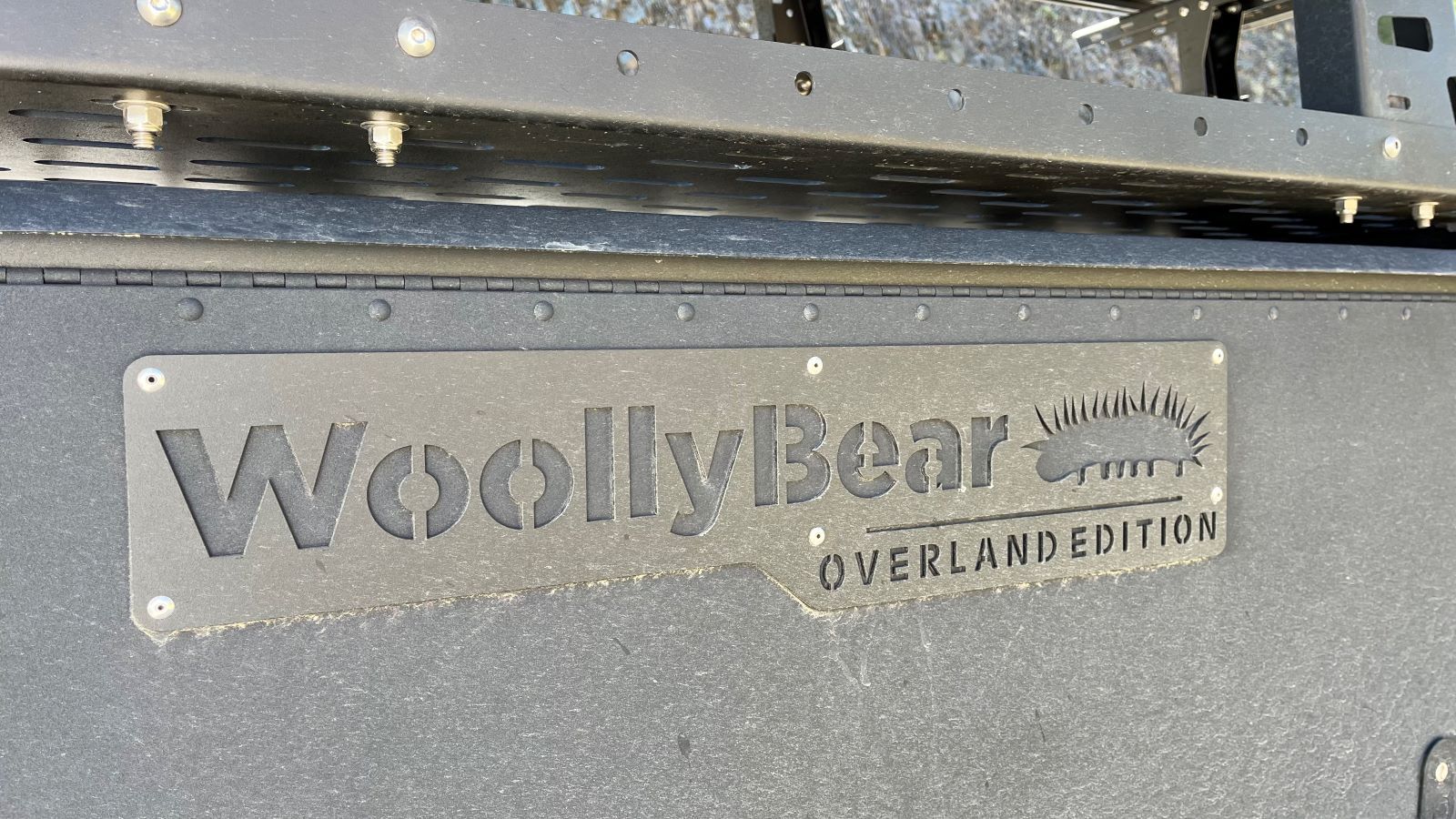 A Bear In Your Campground?!? If It's The Taxa Woolly Bear Camper Trailer, You're in Luck 11 The Emblem On The Side Of The Taxa Woolly Bear Camping Trailer Overland Edition