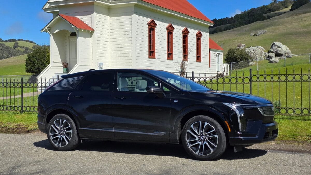 A 2025 Cadillac Optiq EV parked in front of a historic building