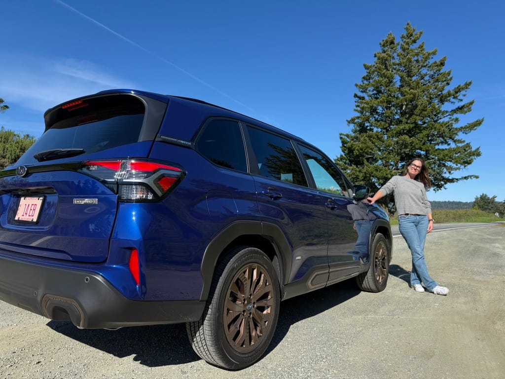Sara Lacey standing next to the Subaru Forester Hybrid