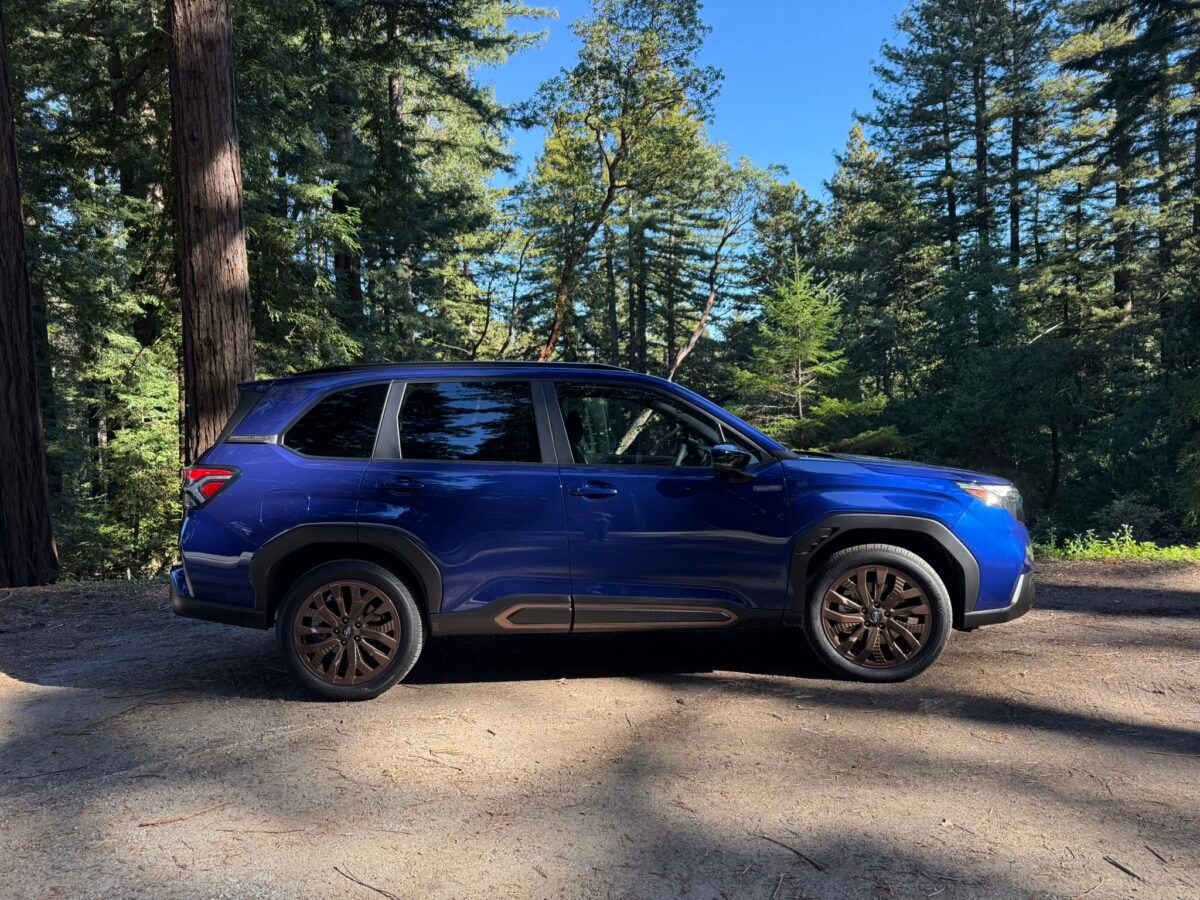 The Side Profile Of The 2025 Subaru Forester Hybrid Parked In A Wooded Area