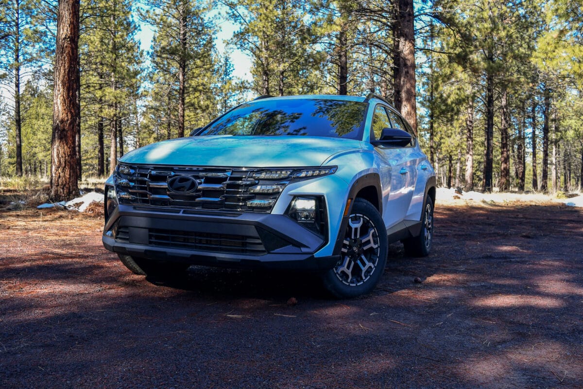 The front end of the Hyundai Tucson XRT on a dirt, wooded road