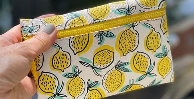 Our Favorite Beauty Essentials To Keep In Your Car 9 Beauty bag in front of a car