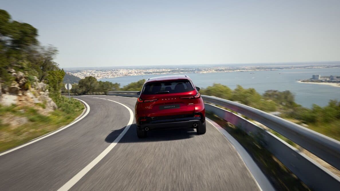 The Rear End Of The Mazda Cx-5 On A Coastal Highway