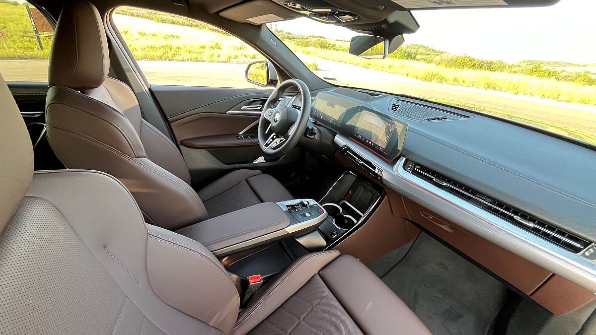The Interior Of The 2024 Bmw X2, Showcasing The Brown Leather And Multimedia Center