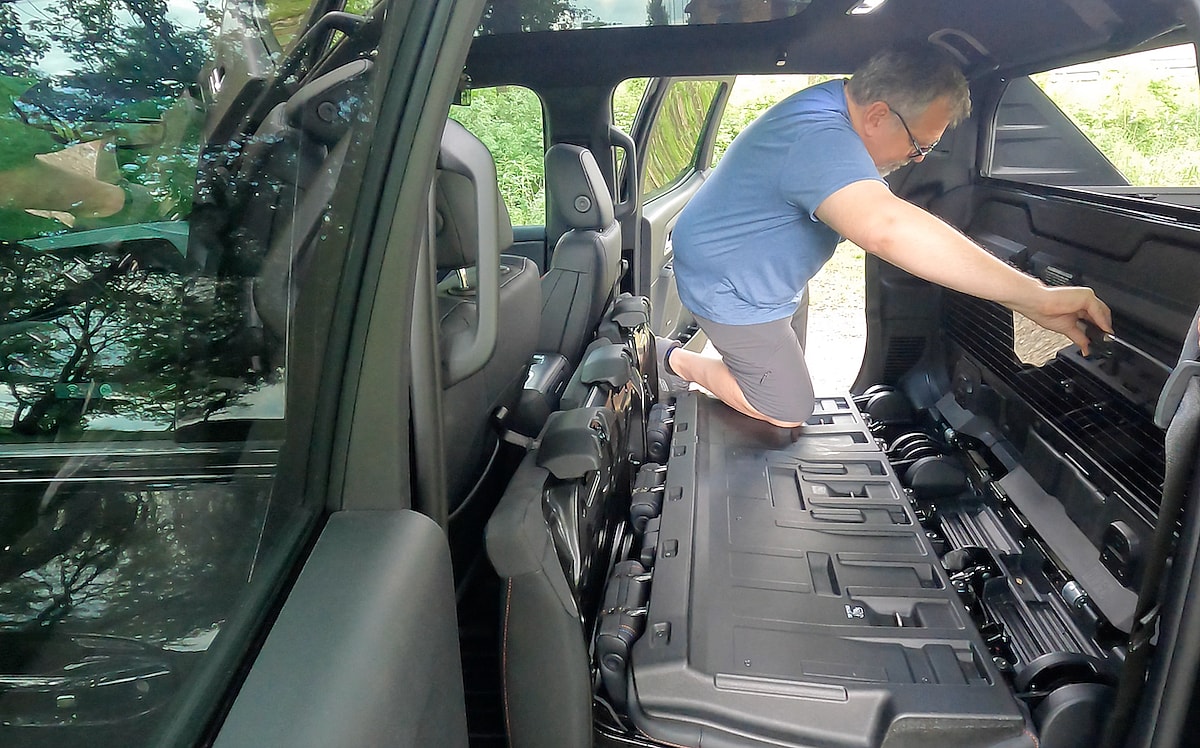 This is the Craziest Pickup Truck Feature - And We LOVE It: Chevrolet Silverado EV Midgate 6 Stow The Glass In The Midgate Panel And Secure