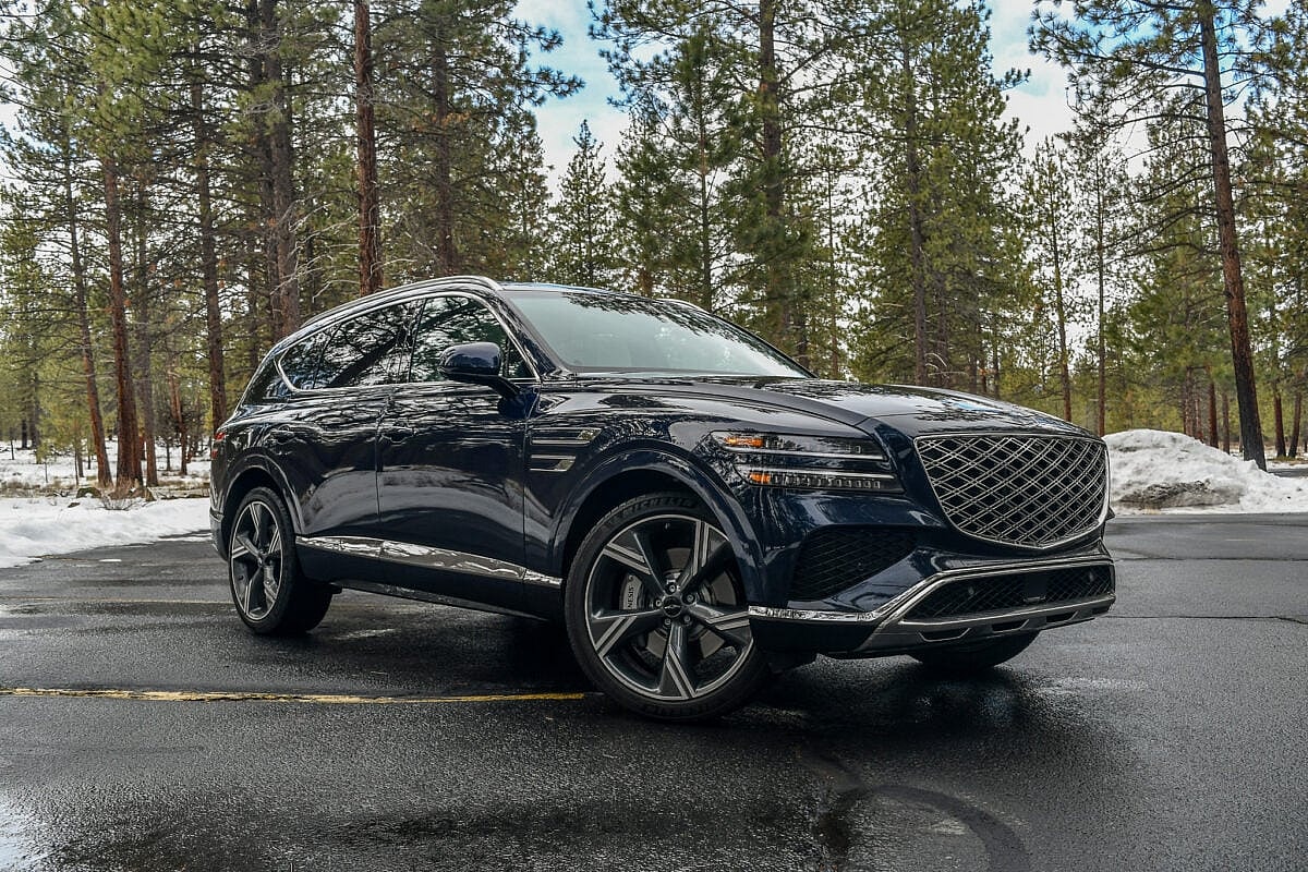 The 2024 Genesis Gv80 In A Wooded Parking Lot
