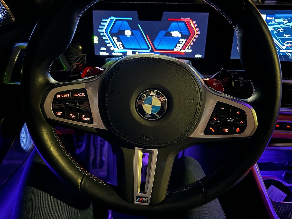 The Steering Wheel And Cabin Light Up At Night In The 2024 Bmw X5 M
