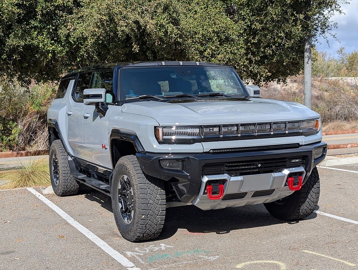 The Hummer Ev Parked In A Parking Spot