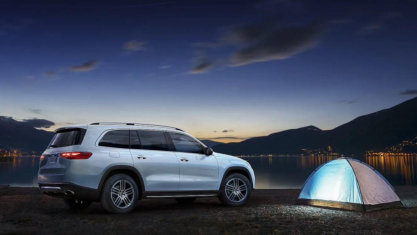 The Mercedes Amg Gls Suv Parked Next To A Riverside Tent