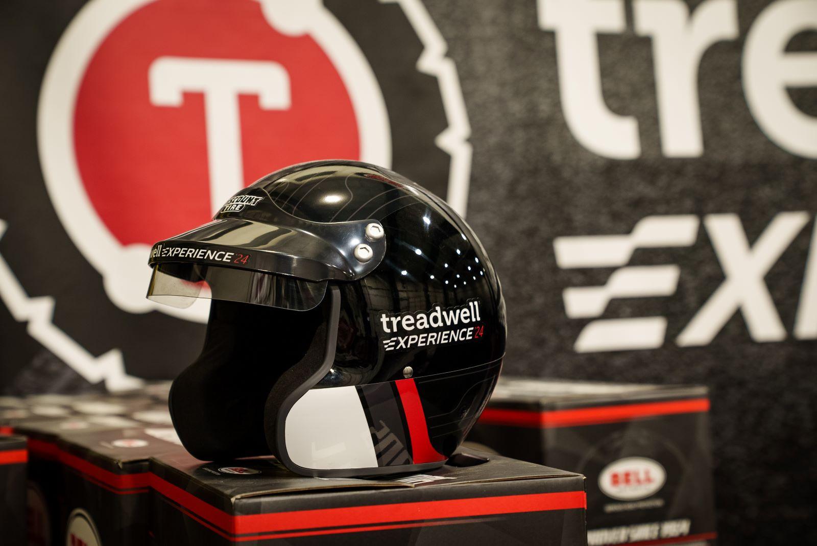 A Treadwell Experience Helmet Sits On A Box With A Treadwell Experience Banner In The Background