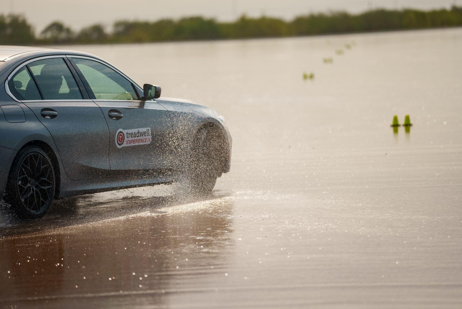 A Bmw 3-Series On A Wet Track To Test The Effectiveness Of Different Tire Types On A Wet Surface