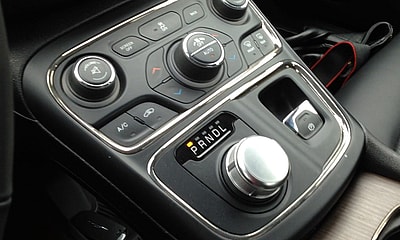 The Car'S Central Controls Include A Dial Gear Shift Which Frees Up Space For Storage And Charging