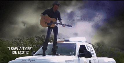 Tiger King Joe Exotic Standing On The Hood And Singing