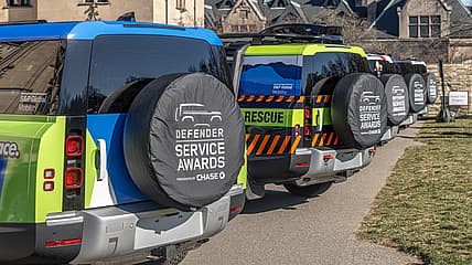 Land Rover Defender Service Award Trucks In A Line
