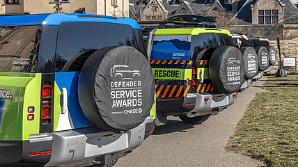 Land Rover Defender Service Award Trucks In A Line
