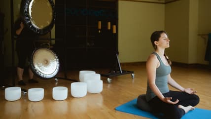 Woman In Lotus Position Doing A Chakra Vibration Therapy At The Woodloch Lodge