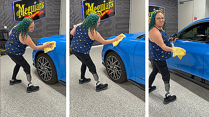 Green Haired Woman Wipes A Car With A Yellow Cloth.