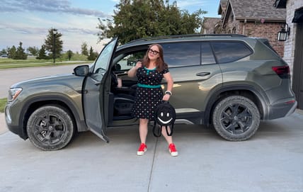 Natalie Merola Standing With The Vw Atlas Peak Edition