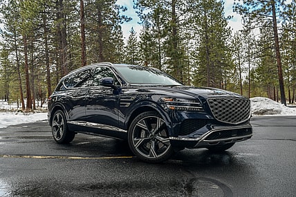 The Jubilance of Luxury Without Judgement: 9 Car Brands That Offer Subtle Sophistication 1 The 2024 Genesis Gv80 In A Wooded Parking Lot