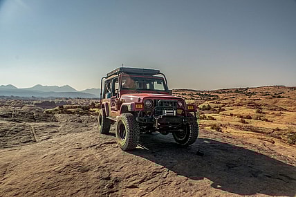 A Flame Red 2006 Jeep Wrangler Unlimited On Moab'S Hell'S Revenge Trail