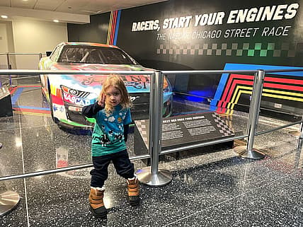 My Son Standing In Front Of A Nascar Race Car