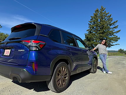 Sara Lacey Standing Next To The Subaru Forester Hybrid