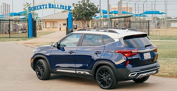 Blue And White 2022 Kia Seltos Outside A Baseball Park