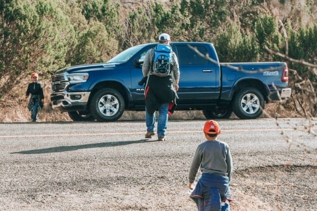 Why your new road trip car just might be a truck - review of the RAM 1500|Man walking toward a truck followed by a little boy in an orange hat