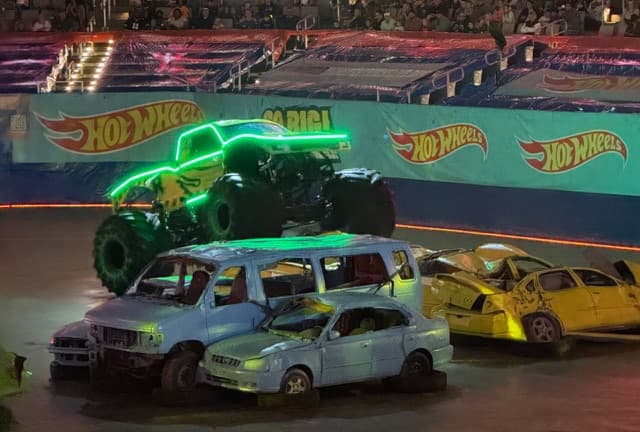 A Monster Truck With Neon Lights Jumping Over Cars As Part Of The Hot Wheels Monster Trucks Live Glow Party In Fort Worth, Texas