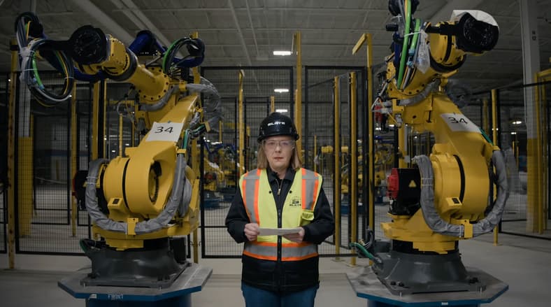 Another Reason Why Slate Auto Charms Us: Meet CEO Chris Barman 2 Chris Barman With Robotic Assembly Plant Machinery At The Slate Auto Assembly Plant