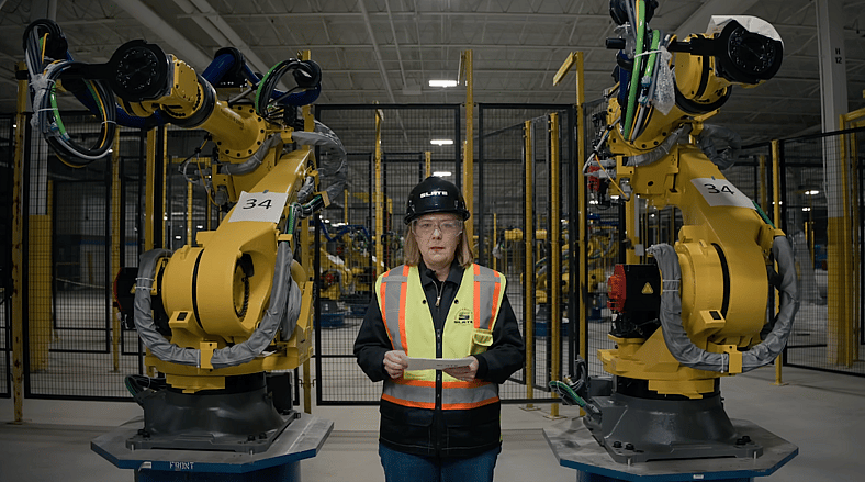 Chris Barman With Robotic Assembly Plant Machinery At The Slate Auto Assembly Plant