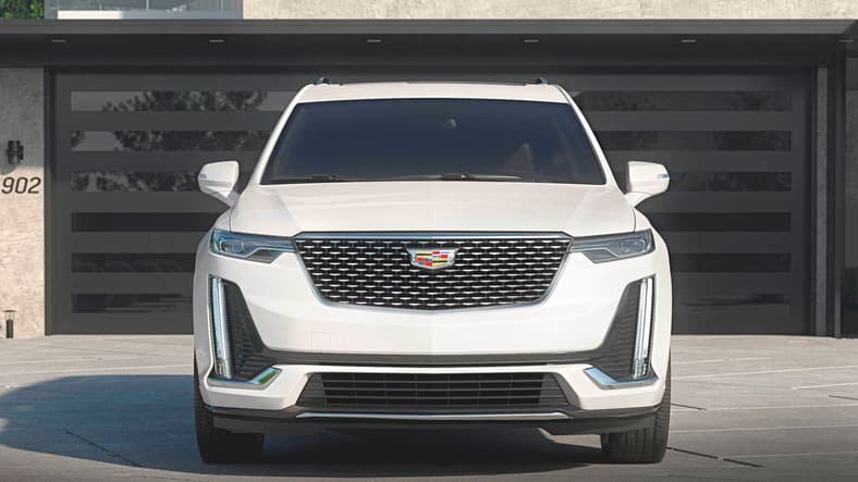 Buy This Not That: Best Luxury SUVs—and the Worst—For Families Who Need 7 Seats 4 The Cadillac Xt6 Parked In Front Of A Garage
