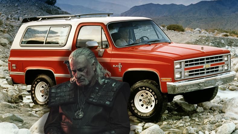 Vesemir Standing Next To A K5 Blazer