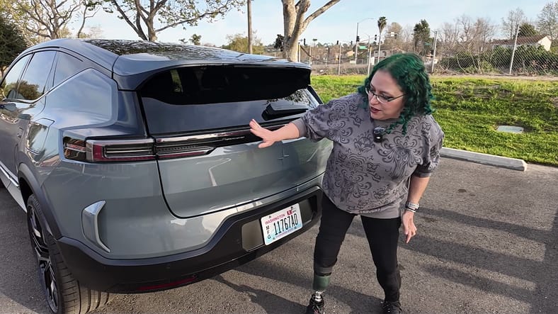 EV Innovation Meets Inclusivity: How the 2025 Polestar 3 Caters to All Drivers 4 Liv Leigh Standing At The Rear Of The Polestar 3, Discussing The Adaptive Taillights