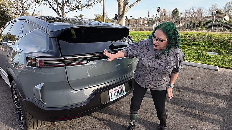 EV Innovation Meets Inclusivity: How the 2025 Polestar 3 Caters to All Drivers 4 Liv Leigh Standing At The Rear Of The Polestar 3, Discussing The Adaptive Taillights