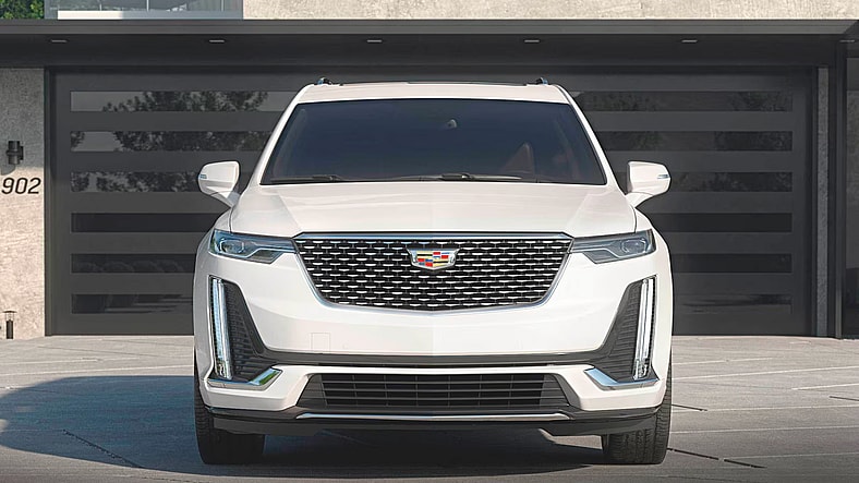 The Cadillac Xt6 Parked In Front Of A Garage