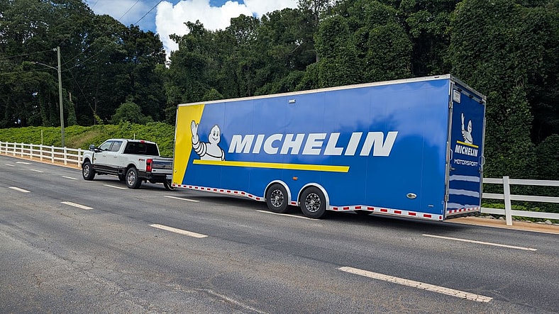 A Ford F-350 Towing A Race Car Trailer
