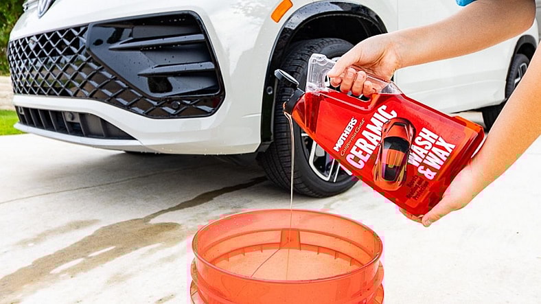 Pouring Mother'S Polish Ceramic Wash And Wax Into A Bucket