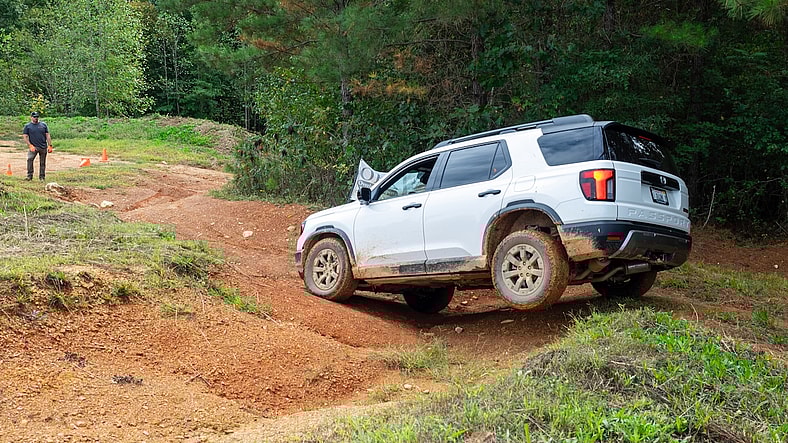 The 2026 Honda Passport Traversing A Muddy Trail