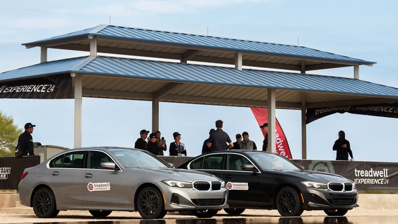 Two Bmw 3-Series Equipped With Two Different Types Of Tires Lining Up To Be Tested On A Wet Surface