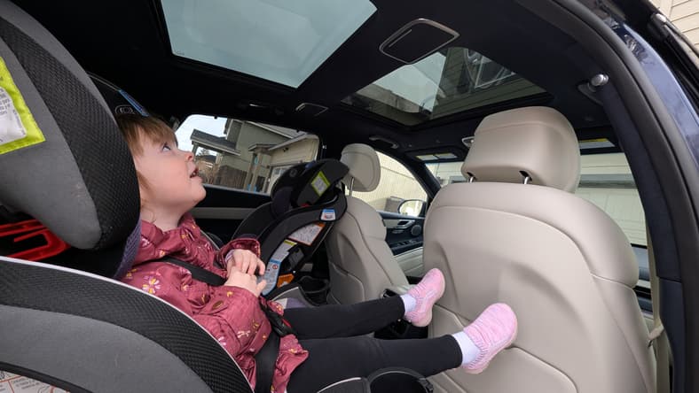 Two Toddlers Enjoying The Gv80'S Large Sunroof, Which Helps Ease Car Sickness
