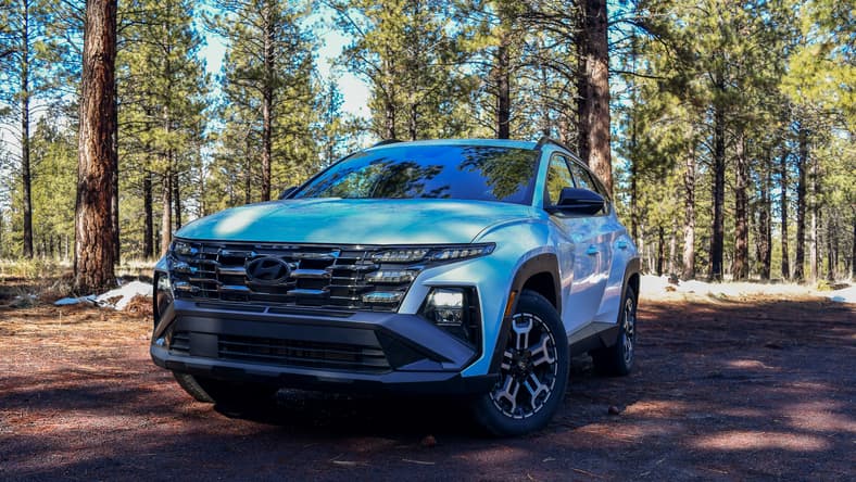 The Front End Of The Hyundai Tucson Xrt On A Dirt, Wooded Road