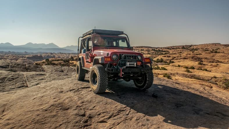 A Flame Red 2006 Jeep Wrangler Unlimited On Moab'S Hell'S Revenge Trail