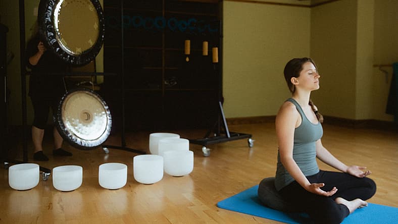 Woman In Lotus Position Doing A Chakra Vibration Therapy At The Woodloch Lodge