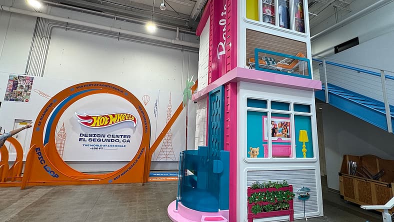 Behind the Scenes at Mattel’s Hot Wheels Design Center Is as Magical As You'd Imagine 1 The Lobby In The Mattel Design Center Features A Super-Size Hot Wheels Track And An Elevator Bank Dressed Up As The Barbie Dream House