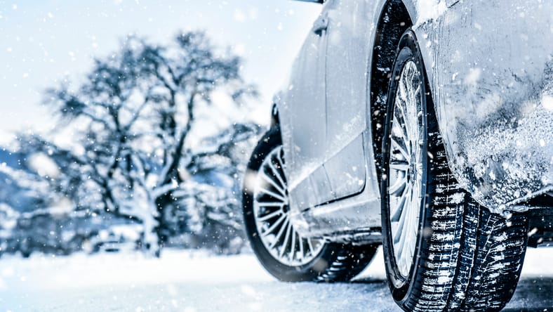 Do You Need Winter Tires? How, and What to Know 2 A Car With Snow Tires Is Parked On Ice To Show Tread Depth And Tire Detail