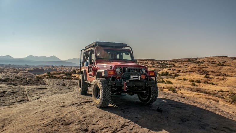 A Flame Red 2006 Jeep Wrangler Unlimited On Moab'S Hell'S Revenge Trail